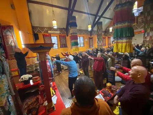 Elders doing guided exercise at a temple