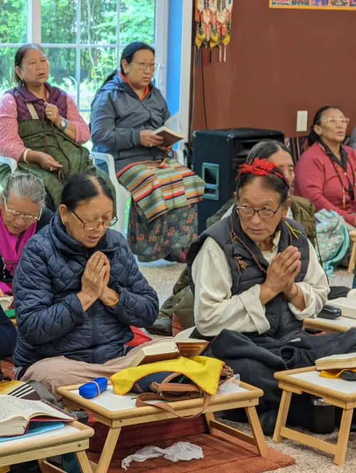 Elders engaged in a communal prayer and reading session