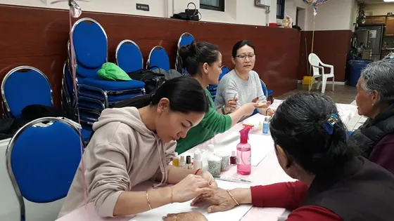 Volunteer providing personal care services to an elder